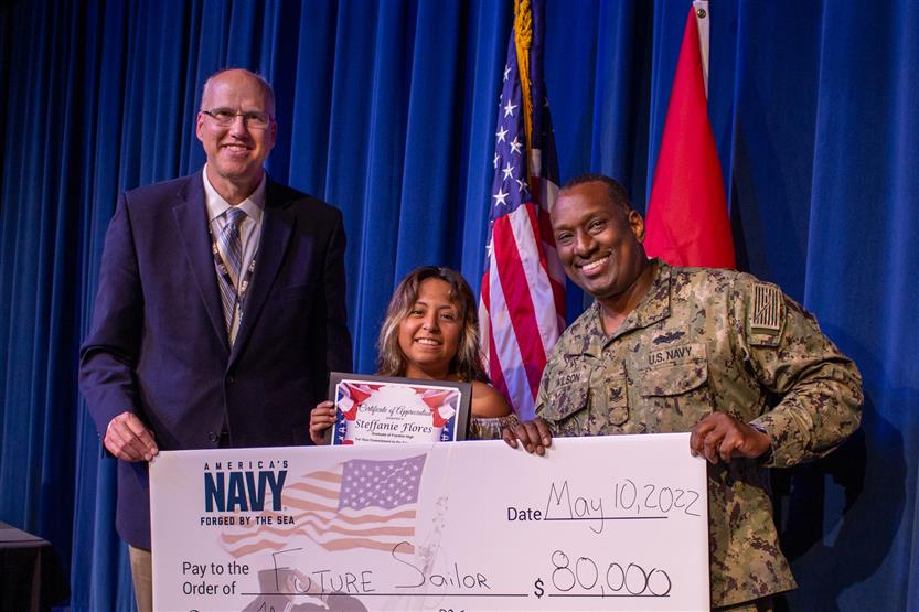 A student is honored for serving in the US Armed Forces after high school
